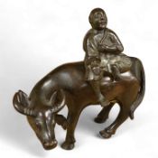 A Chinese bronze buffalo and figural incense burner, 18cm high
