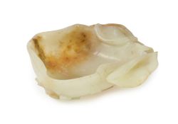 A Chinese pale celadon and russet jade brushwasher, Ming dynasty, 16th/17th century, carved and