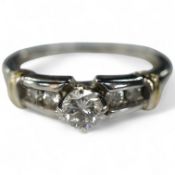 A diamond ring, claw-set with a brilliant-cut diamond weighing approximately 0.30 carats, to