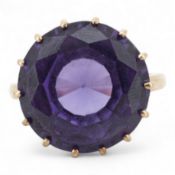 A synthetic colour-change sapphire ring, claw-set with a circular-cut synthetic colour-change