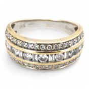 A diamond ring, the wide band set with a line of alternating brilliant-cut and baguette diamonds,