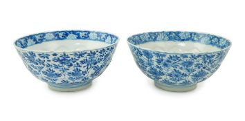 A near pair of Chinese blue and white lotus flower moulded bowls, Kangxi period, each painted to the