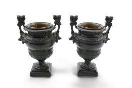 A pair of neoclassical revival bronze urns, late 19th century, each cast with bands of foliage,