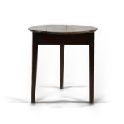 A George III fruitwood and oak cricket table, the circular two piece top on chamfered tapered