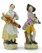 A pair of large Meissen figures of musicians, 19th century, modelled as a woman playing the Hurdy