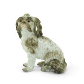 A Meissen figure of a seated Bolognese terrier, 19th century, underglaze blue crossed swords,