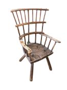 An 18th or 19th century primitive ash and elm Windsor armchair the double bar comb back over a three