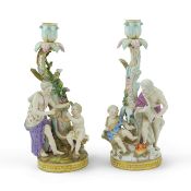 A near pair of Meissen figural candlesticks, late 19th century, each modelled with figures