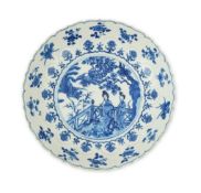 A Chinese blue and white ‘ladies and phoenix’ dish, Kangxi period, the lotus petal moulded dish,