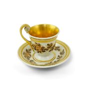 A Furstenberg cup and saucer, c.1800, the high handled Empire shaped cup and saucer painted in brown
