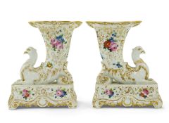 A pair of Paris porcelain cornucopia vases, mid 19th century, each modelled with a griffin’s head