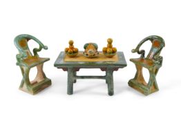 A set of Chinese Ming Sancai models of table with offerings and a pair of horseshoe shaped