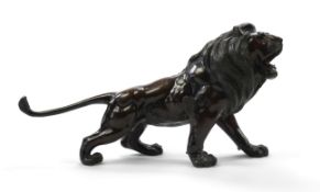 A Japanese patinated bronze okimono of a roaring lion, Meiji period, naturalistically cast