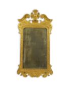 A George II carved giltwood wall mirror with central urn and scroll pediment over a rectangular