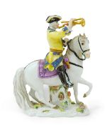 A Meissen group of a bugler on horseback, early 20th century, modelled on a flower encrusted base,
