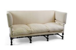 A Jacobean revival Knowle type three seater sofa upholstered in antique natural French linen on