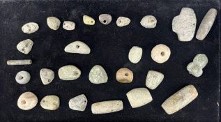 A group of pre-Colombian jadeite and stone beads from a necklace, and three similar jadeite