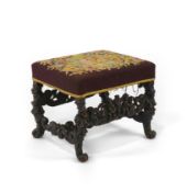 A Charles II walnut dressing stool with later polychrome tapestry seat on heavily carved figural and