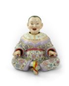 A large Continental porcelain figure of a seated nodding Buddha, early 20th century, after the