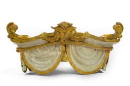 An Italian gilt wood and cream painted canopy, 19th century, carved with swags and tassels the