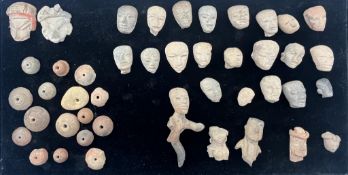 A group of pre-Colombian terracotta heads, a partial figure and beads, Mexico, including two