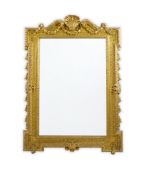 A late 19th century French carved gilt wood and composition overmantel mirror with swagged scallop
