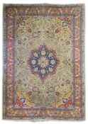 An early 20th century Tabriz pale green ground carpet the central lobed medallion within a scattered