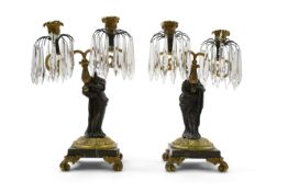 After Mathurin Moreau. A pair of mid 19th century bronze and gilt bronze two branch candelabra