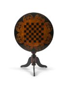 A 19th century Ceylonese ebony and specimen wood chess table, the circular top veneered with