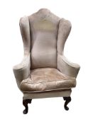 A Queen Anne Revival upholstered wing armchair, width 79cm, depth 60cm, height 116cm