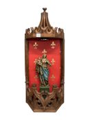 A Gothic Revival carved oak niche with plaster Madonna and child, height 104cm