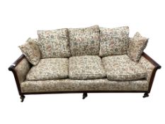 An early 20th century mahogany bergere settee, now upholstered, width 196cm, depth 92cm, height