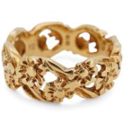 An early 1970's 18ct gold band, of pierced foliate design, maker I.G., London, 1971, size K, 5