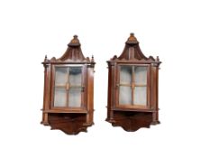 A pair of small late Victorian mahogany hanging corner cabinets, width 48cm, depth 26cm, height