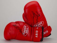 A pair of red boxing autographed boxing gloves