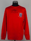 A red replica England Geoff Hurst and Martin Peters 50th Anniversary autographed shirt.