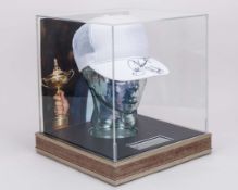 Seve Ballesteros and Padraig Harrington autographed white cap display