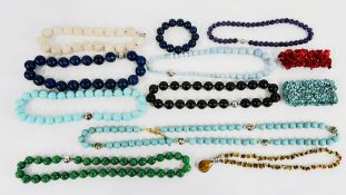 A TRAY OF POLISHED HARD STONE BEADED NECKLACES.