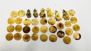 A BAG CONTAINING A GROUP OF ETHNIC YELLOW METAL TOKENS.