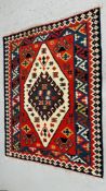 A RED / GREEN / BLUE AZTEC PATTERNED CARPET 140CM X 190CM.