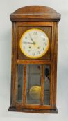 A VINTAGE OAK CASED WALL CLOCK MARKED 