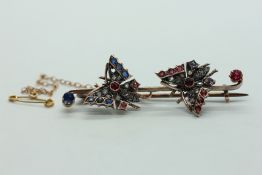 A VICTORIAN YELLOW METAL BUTTERFLY BROOCH SET WITH OLD CUT DIAMOND AND COLOURED STONES IN A VINTAGE