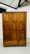 A HONEY PINE TRIPLE WARDROBE WITH TWO DRAWERS TO BASE W 132CM D 56CM H 190CM.