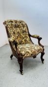 A VICTORIAN OPEN ARM CHAIR WITH BUTTON BACK FLORAL UPHOLSTERY.