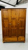 A HONEY PINE TRIPLE WARDROBE WITH TWO DRAWERS TO BASE W 132CM D 56CM H 190CM.