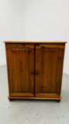 HONEY PINE TWO DOOR CUPBOARD WITH SHELVED INTERIOR W 83CM D 39CM H 91CM.