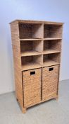 A SEA GRASS WOVEN STORAGE UNIT WITH LOWER LAUNDRY BINS.