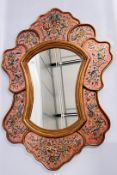 AN ORNATE SHAPED WALL MIRROR OVERALL HEIGHT 101CM.