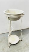 ANTIQUE WHITE PORCELAIN WASH BOWL IN WROUGHT METAL STAND.