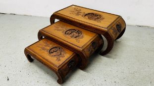 A C20th ORIENTAL CARVED HARDWOOD NEST OF THREE TABLES, THE LARGEST 93CM.